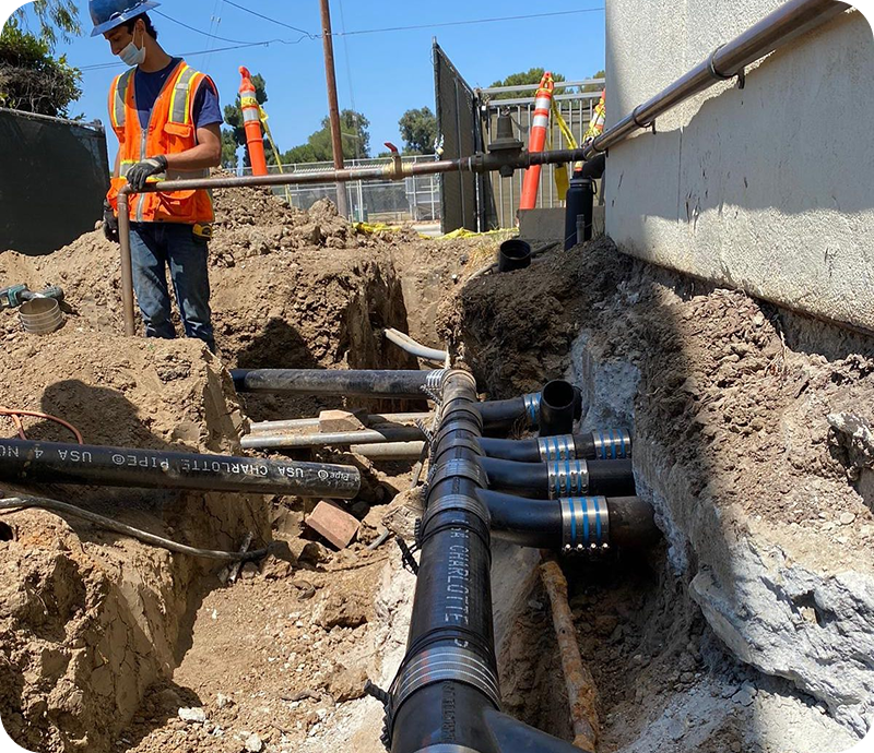 Pipe installation next to building foundation